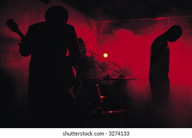 A Jazz Band Shot In Silhouette While Performing In A Club