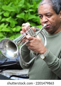 Jazz Musician Blowing His Flugelhorn Outside.