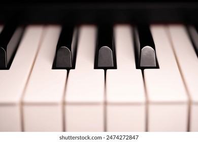 Jazz Piano Keys. Close-up of piano keys, focused on one note, with foreground and background fading into the distance.Music concept theme