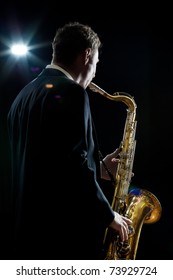 A Jazz Saxophone Player Facing The Audience As He Plays In A Club - Intentional Flare