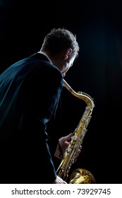 A Jazz Saxophone Player Facing The Audience As He Plays