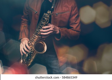 Jazz Saxophone Player In Performance On The Stage. Color Filter And Hexagon Bokeh Added.