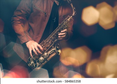 Jazz Saxophone Player In Performance On The Stage. Color Filter And Hexagon Bokeh Added.