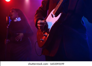 A Jazz Singer And Guitarist Perform On Stage.