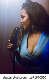 A jazz singer performs on stage. Afro.