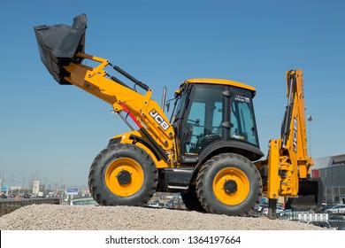 The JCB all-wheel drive backhoe loader stands on the advertising stand in the south of the city. Inscription on a tractor - made in Russia SAINT-PETERSBURG, RUSSIA - 7 APRIL 2019.
