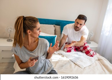 Jealous Suspicious Mad Husband Arguing With Obsessed Wife Holding Phone Texting Cheating On Cellphone, Distrustful Boyfriend Annoyed With Girlfriend Mobile Addiction, Distrust Social Media Dependence