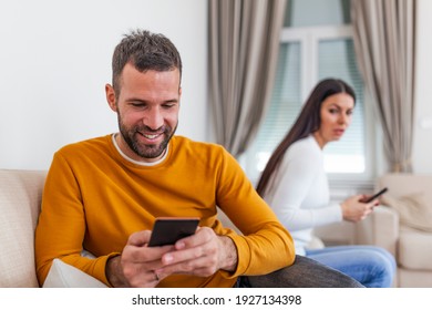 Jealous Suspicious Mad Wife Arguing With Obsessed Husband Holding Phone Texting Cheating On Cellphone, Distrustful Girlfriend Annoyed With Boyfriend Mobile Addiction, Distrust Social Media Dependence