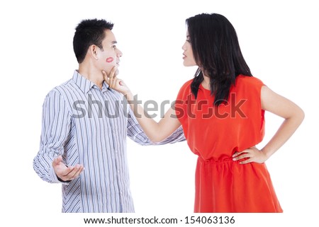 Jealous woman looking at her kissed man isolated on white background