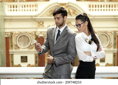 Jealous woman looking at her partner chatting on the phone