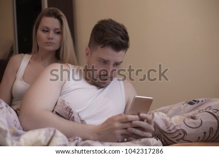 Jealous woman spying his husband.