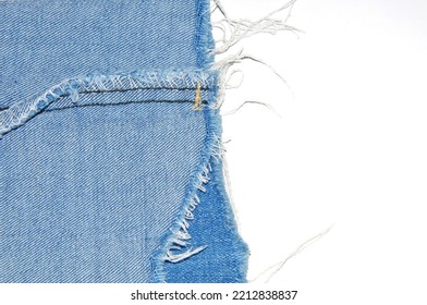 Jean denim texture, ripped blue fabric on white background