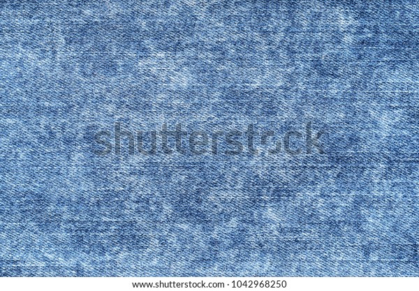 Jeans in acid wash blue. Denim background, texture,\
close up. Faded wash