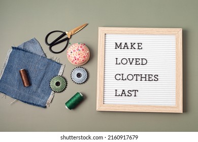 Jeans with letter board and text made loves clothes last. Slow fashion, circular economy, eco friendly sustainable shopping, thrifting second hand shop concept.