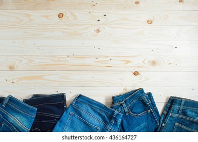 Jeans on a wooden plate with a white background.