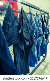 Jeans Pants Getting Spray Paints For Special Effects In Denim Manufacturing Factory.