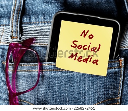 In jeans pocket, handwritten note stick on mobile phone NO SOCIAL MEDIA, decision making to stay away from social media to gain more time to something else, less distracted and less stressed