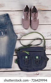 Jeans, Sneakers And Messenger Bag. Casual Style Combination For Comfort Walk. Top View On A Display Of The Store. Women's Clothing And Footwear.