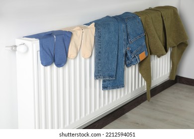 Jeans, Socks And Cardigan On Heating Radiator Indoors