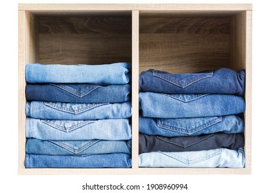 Jeans stack on the shelves in the store at supermarket.