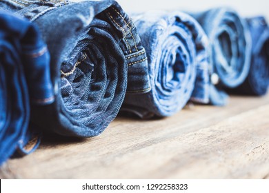 Jeans Stacked On Wooden Background Stock Photo 1292258323 | Shutterstock