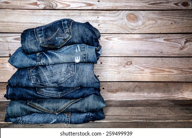 jeans stacked on a wooden background