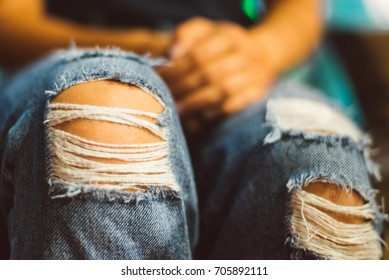 Jeans torn at the knee close up