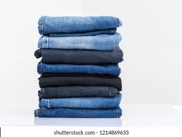 
Jeans trousers stack on white background
