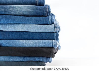 Jeans trousers stack on white background and space for text design concept