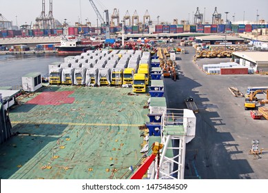 Jebel Ali, UAE, November 15, 2008. Unloading Heavy Equipment And Trucks From The Ro-Ro Vessel In The Port Of Jebel Ali