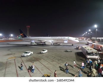 JEDDAH, SAUDI ARABIA - MAY 06, 2018: King Abdulaziz International Airport With Planes And Passengers At Night.