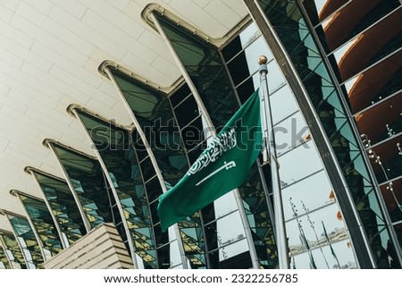 Jeddah, Saudi Arabia May 20 2023  Saudi flag waving in the wind in front of the Terminal 1 at the King Abdulaziz International Airport 