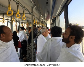 JEDDAH, SAUDI ARABIA-DECEMBER 20 2017: Man In Ehram Clothes Ride A Bus At Jeddah International Airport To Departure Hall Upon Arrival From Dubai