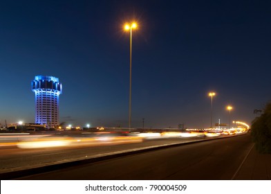 Jeddah Water Tower At Night, With Car Lights Motion On The Street. Saudi Arabia