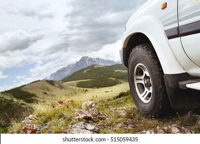 Jeep Car Wheel On Hill Top On Background Of Mountains. Siberia, Russia