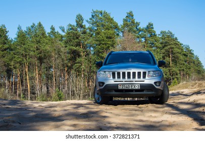 Jeep compass in the forest. Aprill 2015. Republic of Belarus