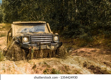 Jeep Crashed Into A Puddle And Picked Up A Spray Of Dirt. Off Road Sport Truck Between Mountains Landscape. Track On Mud. 4x4 Off-road Suv Car. Offroad Car. Safari. Best Off Road Vehicles