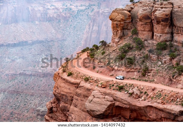 Jeep Driving Near the\
Edge of a Cliff