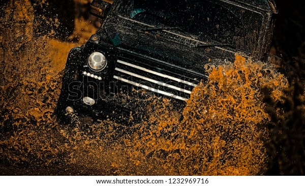 Jeep outdoors adventures. Rally racing. Road\
adventure. Adventure travel. Tracks on a muddy field. Mud and water\
splash in off-road racing