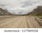 A jeep pulls over in a pull out for a beak after descending from Antigun Pass to the Antigun Valley on the way to Deadhorse. Dalton Highway, Alaska.