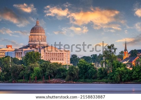 Jefferson City, Missouri, USA downtown view on the Missouri River with the State Capitol at dusk.
