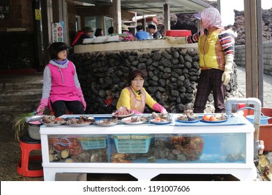 
Jeju Island - April 2018 : Group of Haenyeo selling fresh seafood at Jeju woman diver (Haenyeo) performance location in Jeju Island, South Korea. Haenyeo are traditional breath-hold women divers.