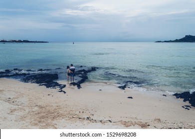 Jeju Island, South Korea, September 05, 2019: Lovely Asian Couple Standing In The Sea At Geumneung Beach Holding Their Hands 