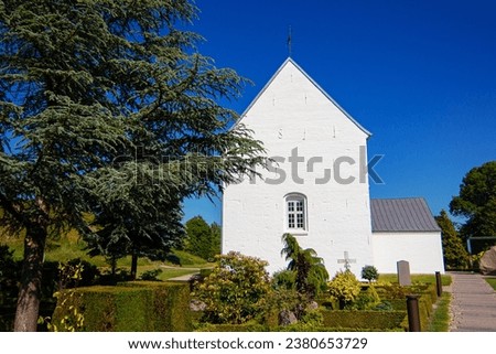 Jelling Church and small local cemetery in Jelling village at North Jutland, Denmark.  It was built of limestone around the year 1100. UNESCO World Heritage Site