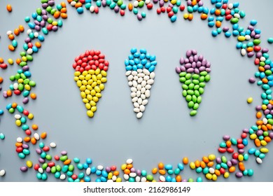 Jelly Bean Creativity: Bright Jellybeans Laid Out In Shape Of Ice Cream Cones In Frame On Gray Background