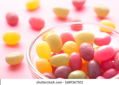 Jelly Beans Spill From Open Glass Bottles And Metal Fasteners II
Colorful Mixed Fruity Jelly Beans On Background