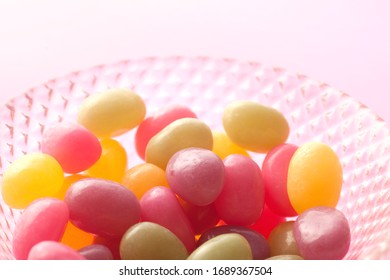 Jelly Beans Spill From Open Glass Bottles And Metal Fasteners II
Colorful Mixed Fruity Jelly Beans On Background