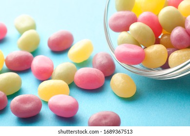 Jelly Beans Spill From Open Glass Bottles And Metal Fasteners II
Colorful Mixed Fruity Jelly Beans On Background