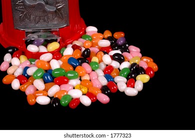 Jelly Beans Surrounding A Jelly Bean Dispenser Isolated On Black