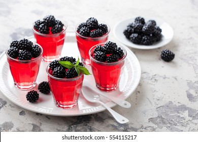 Jelly dessert with fresh blackberries served in glass, selective focus